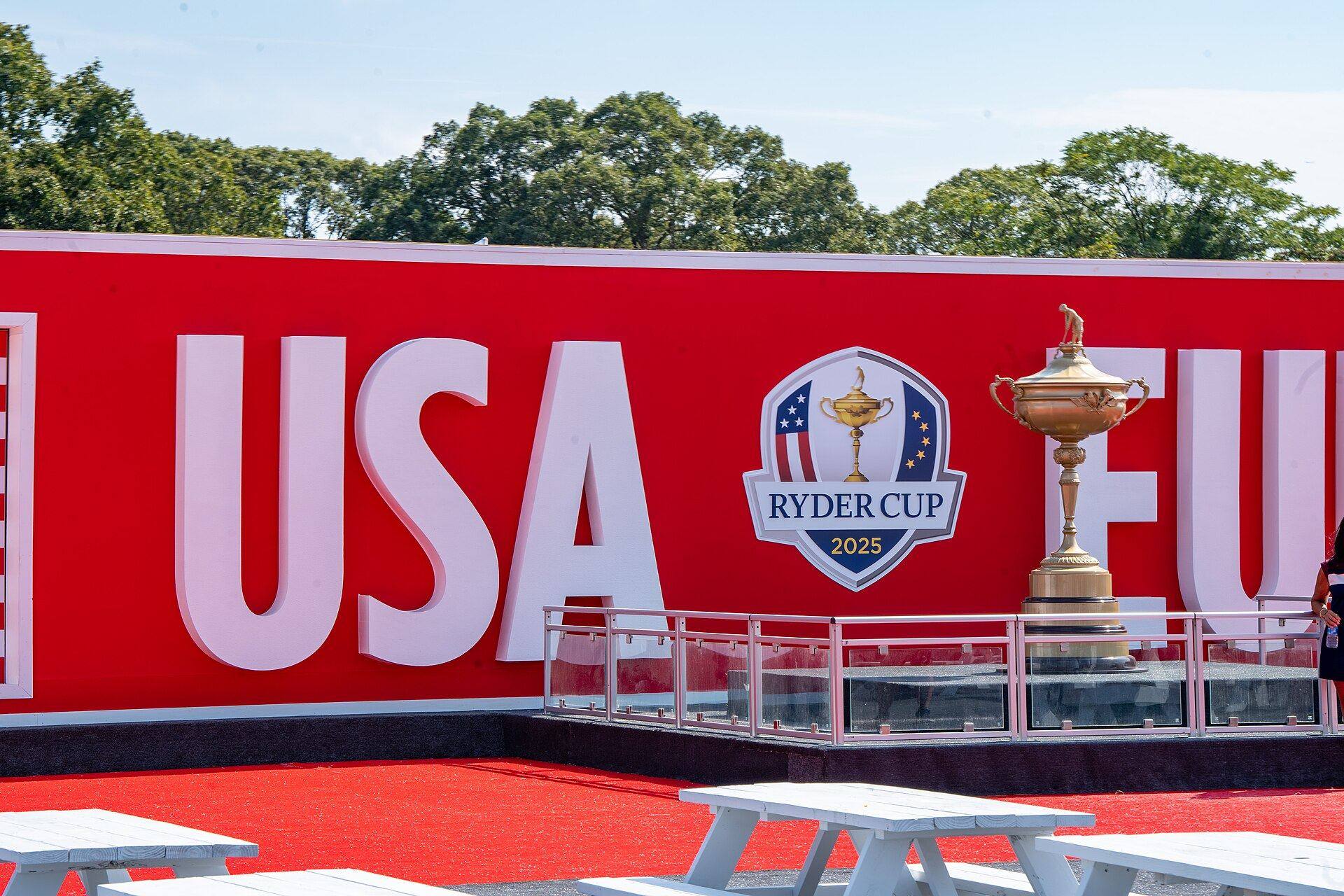 The Ryder Cup trophy on display in front of a red USA and Europe banner